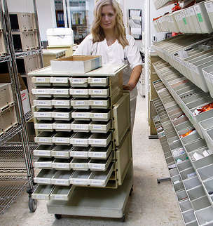 Pharmacy technician delivering mediations in a hospital.