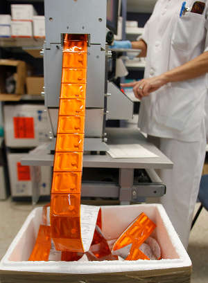 Pharmacy technician prepacking unit doses of medication.